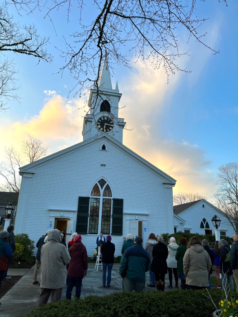 congregation on steps of church at dawn